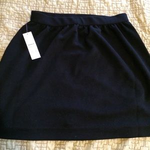 Elle- Short black skirt. Ribbed material.